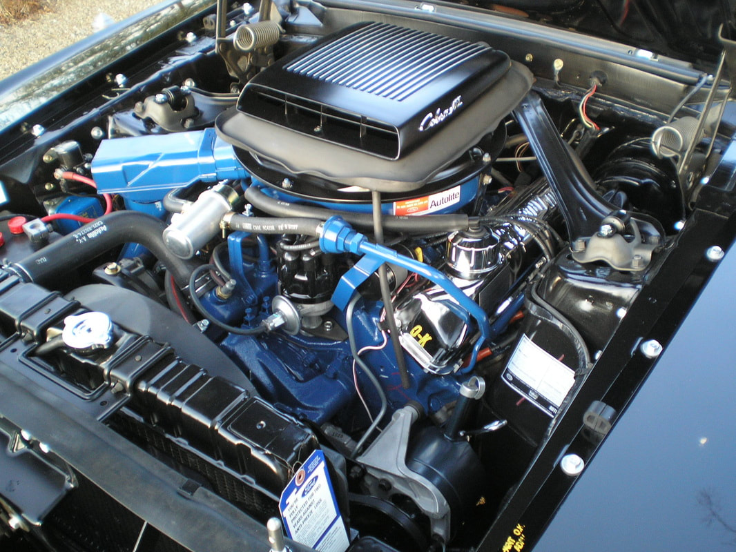 Close-up of a detailed car engine with wiring and components.