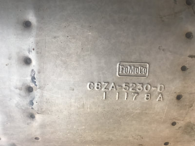 Metal surface with embossed serial and model numbers.