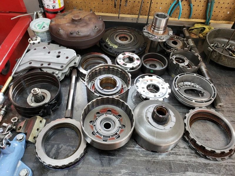 Assorted mechanical parts on a workshop table.
