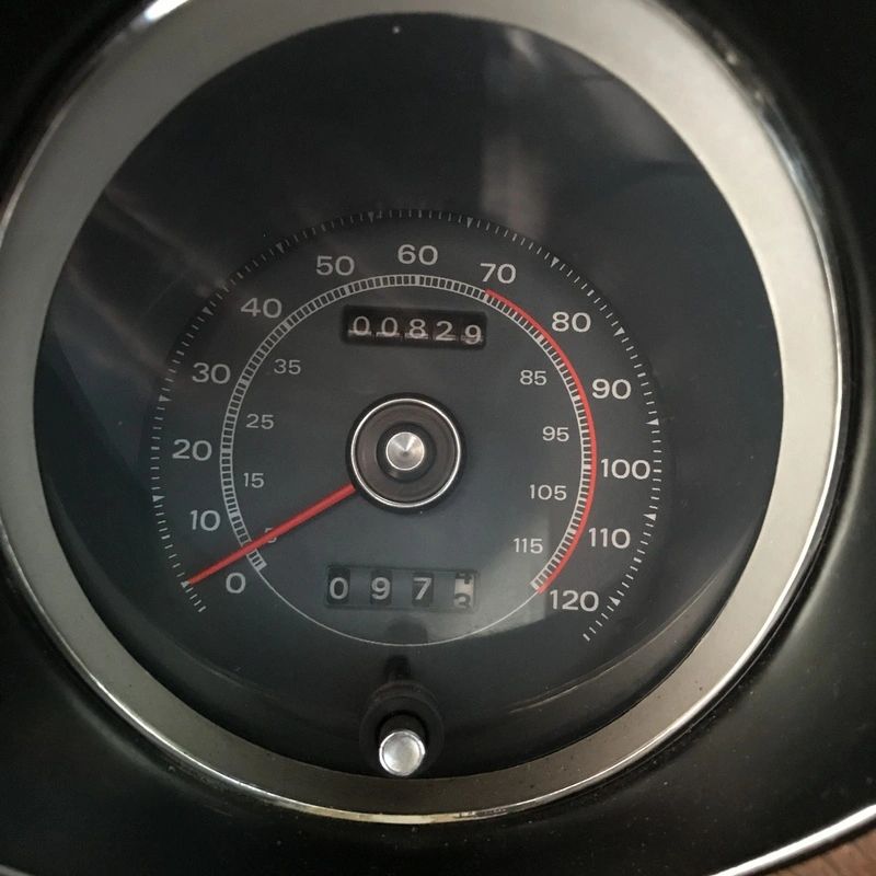 Classic car speedometer showing low mileage.