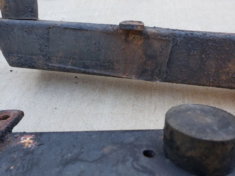 Rusty metal parts on concrete surface.