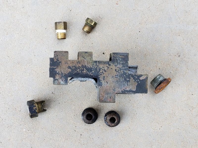 Metal fittings and a rusty tool piece.