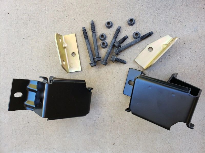 Metal brackets and bolts on beige surface.