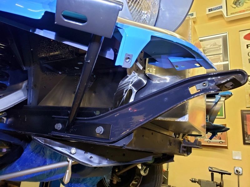 Car undercarriage with visible structural components.