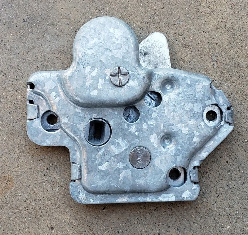 Metal lock mechanism on concrete surface.