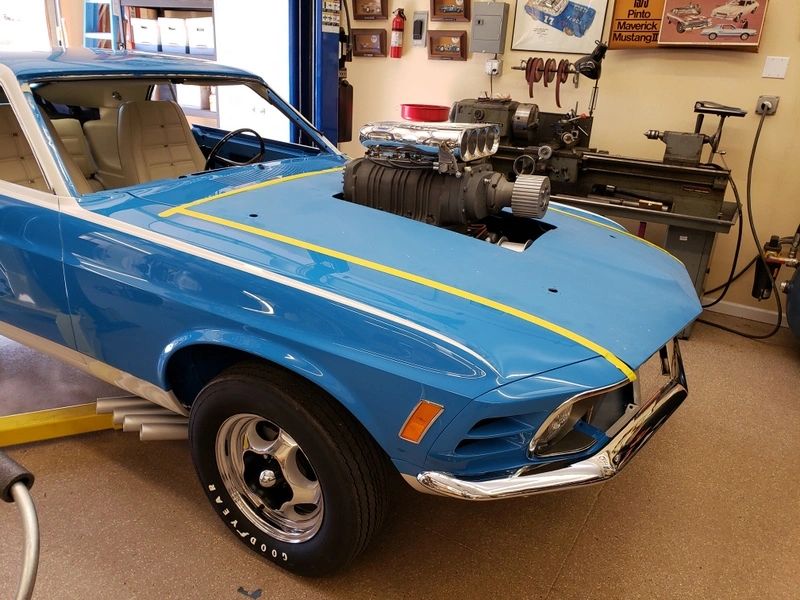 Blue classic car with engine modification.