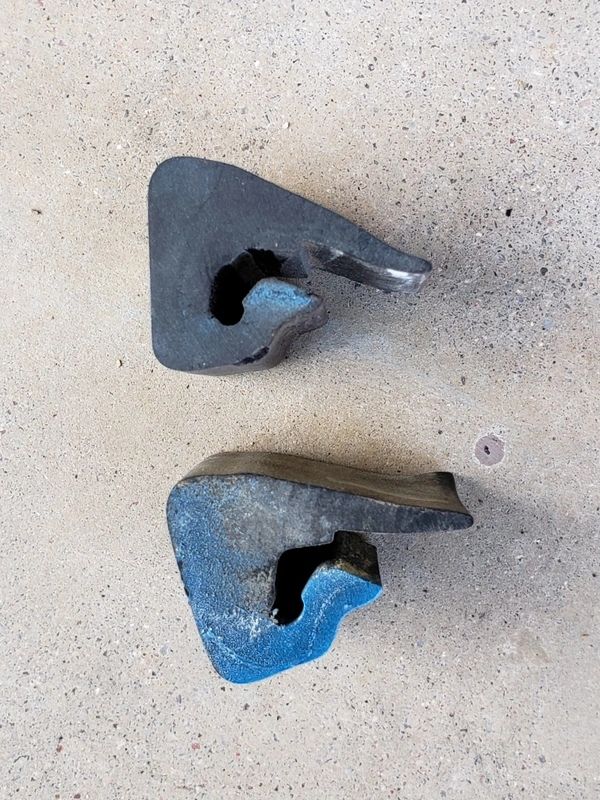 Two uniquely shaped black and blue objects.