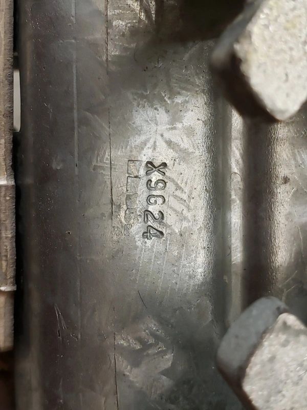 Metal surface with engraved code X9G24.