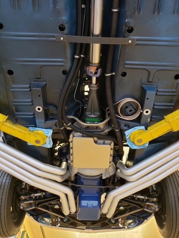 Car undercarriage showing exhaust system and suspension.