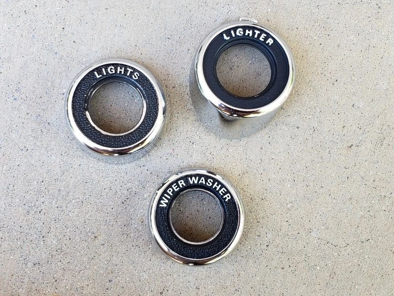 Three vintage car dashboard knob surrounds.