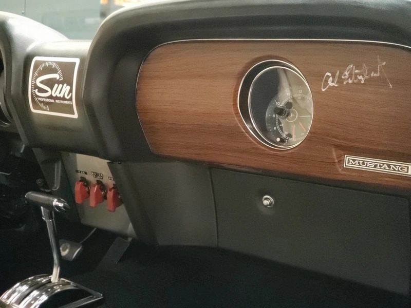 Vintage Mustang dashboard with wooden panel.