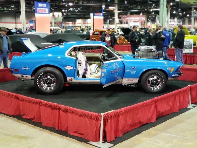 Blue classic car on display at show.