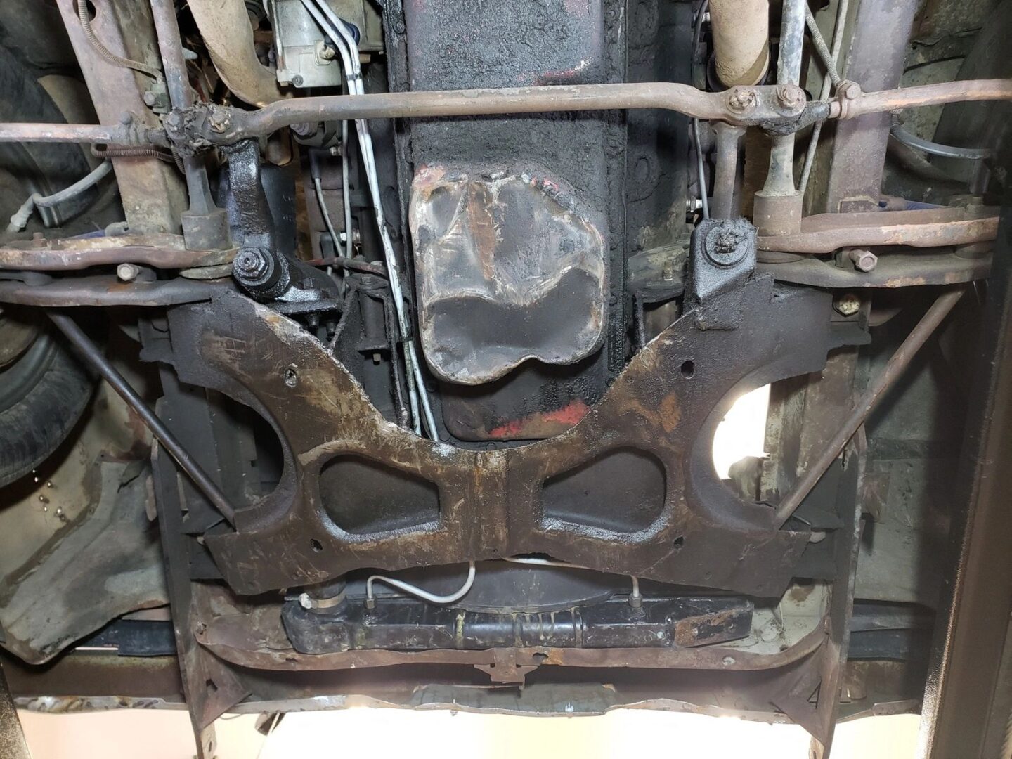 Car undercarriage showing suspension and exhaust system.