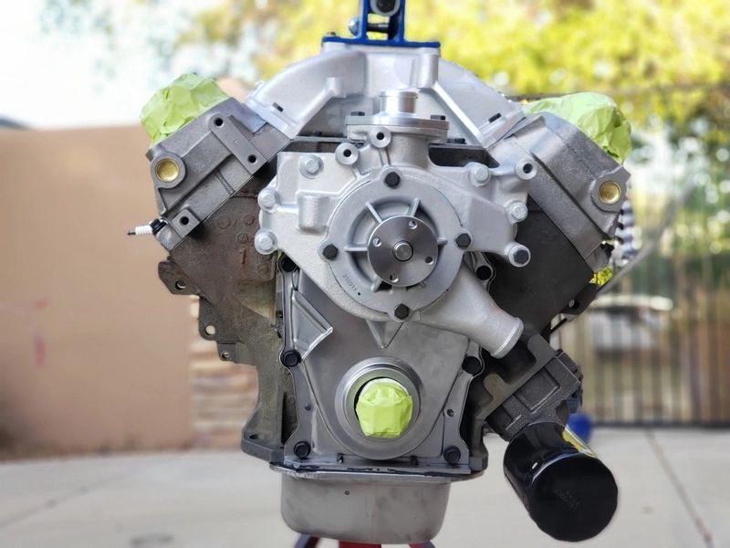 Car engine on display stand outdoors.