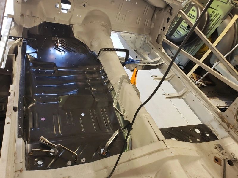 Car interior with exposed metal floor.