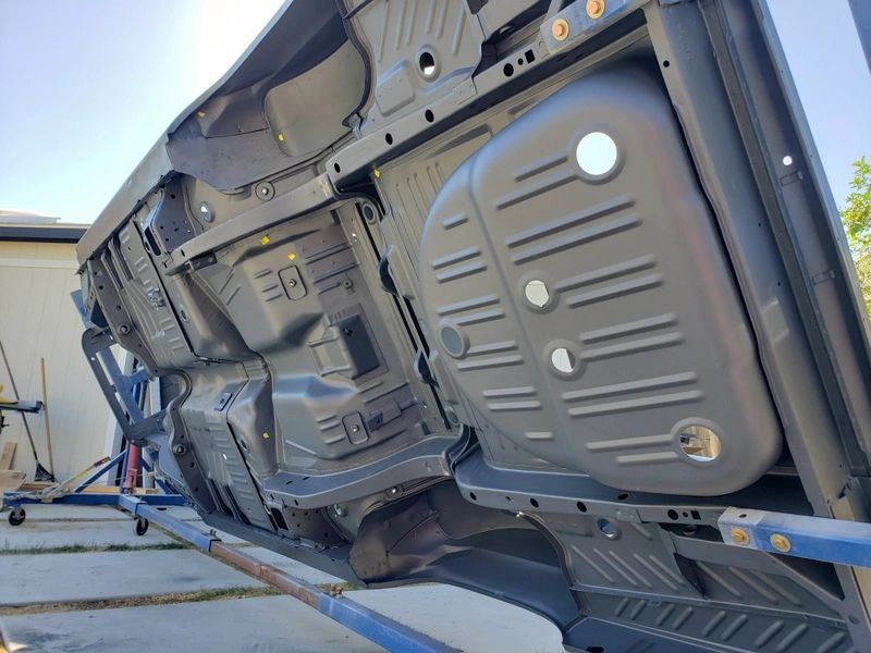Underside of a vehicle on rotisserie.