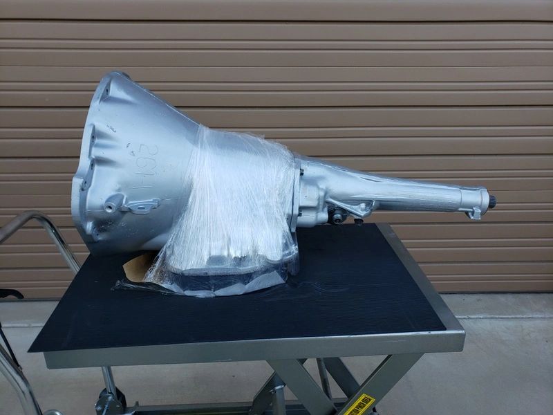 Transmission wrapped in plastic on a cart.