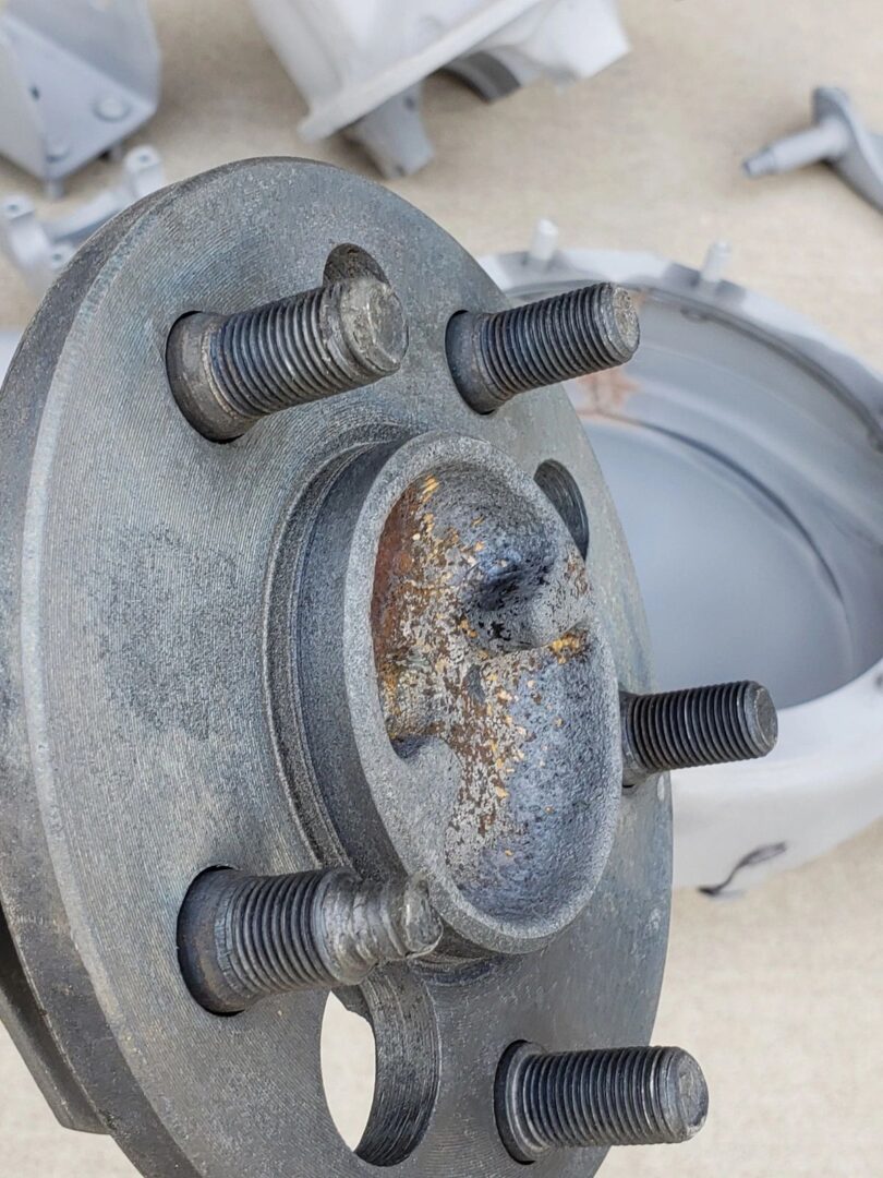 Rusty wheel hub with five bolts.