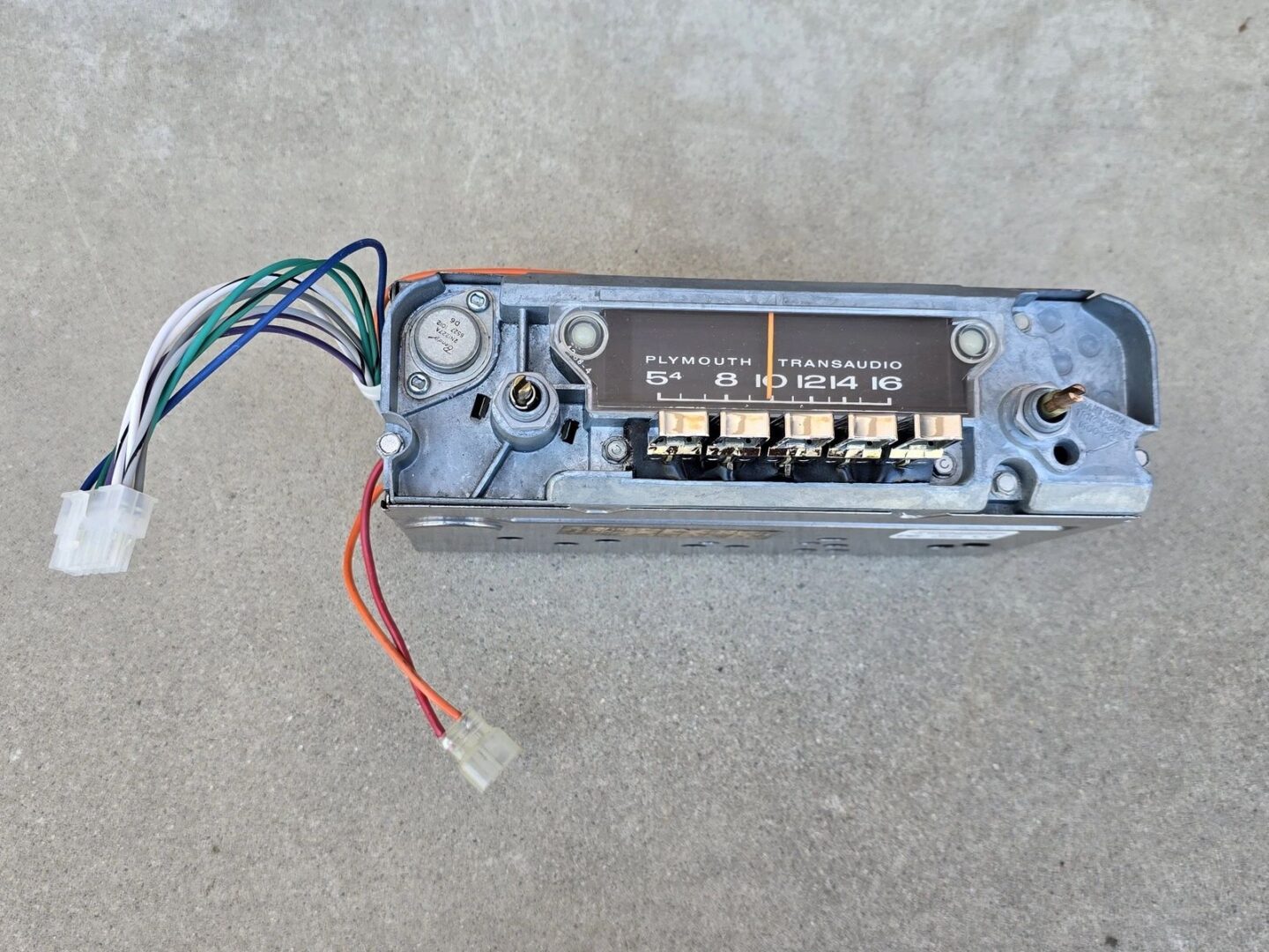 Vintage car radio with exposed wiring.