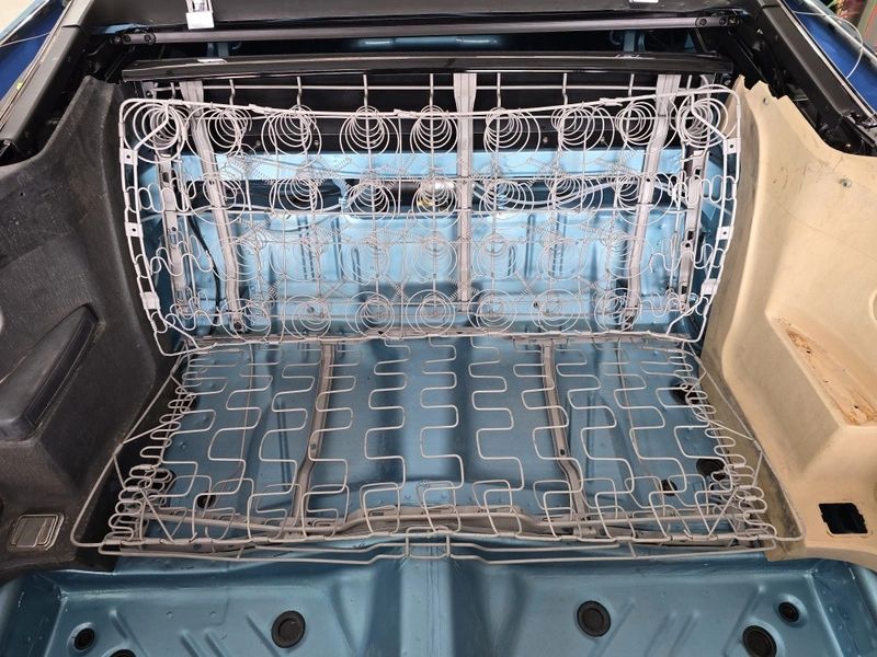 Car trunk with exposed seat springs.