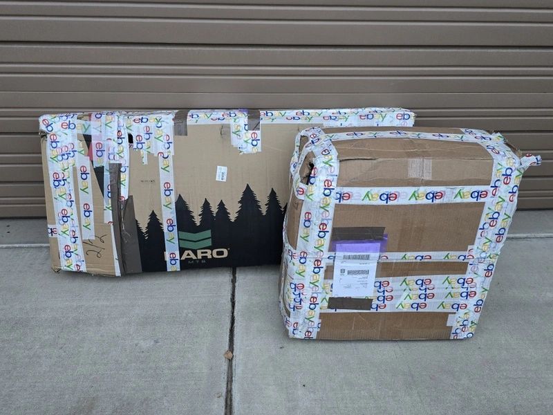 Two cardboard boxes sealed with eBay tape.