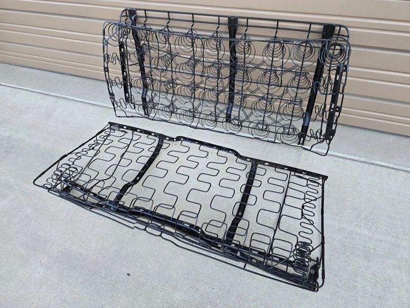 Metal car seat frames on concrete floor.