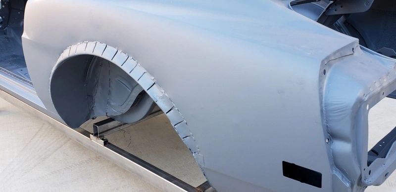 Car body with gray primer coating.