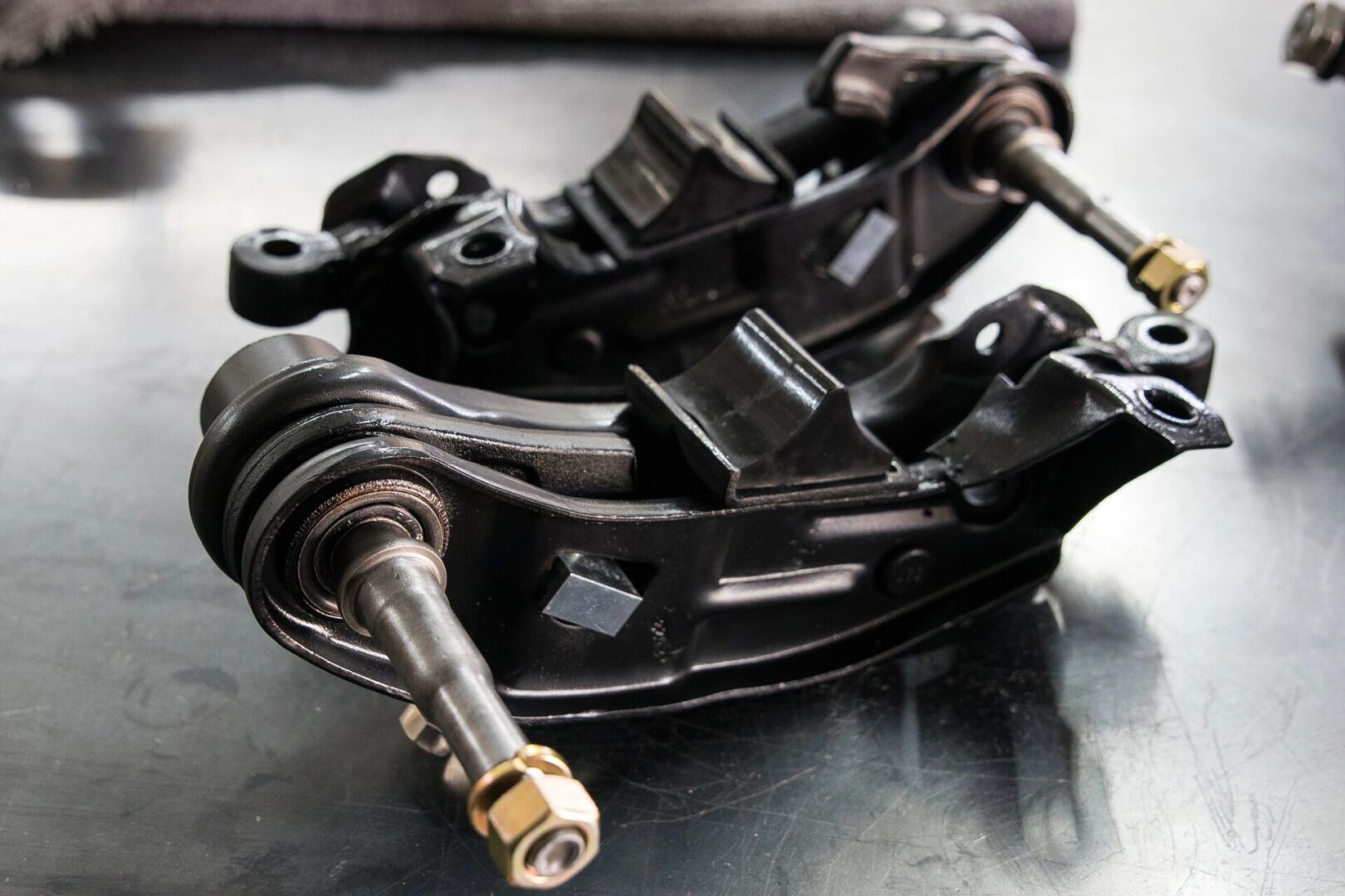 Car suspension parts on metal surface.