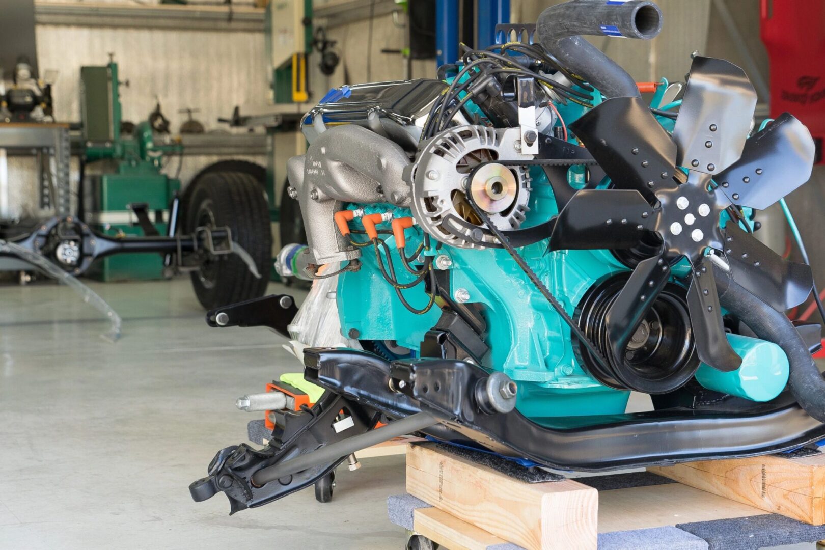 Car engine in a workshop setting.