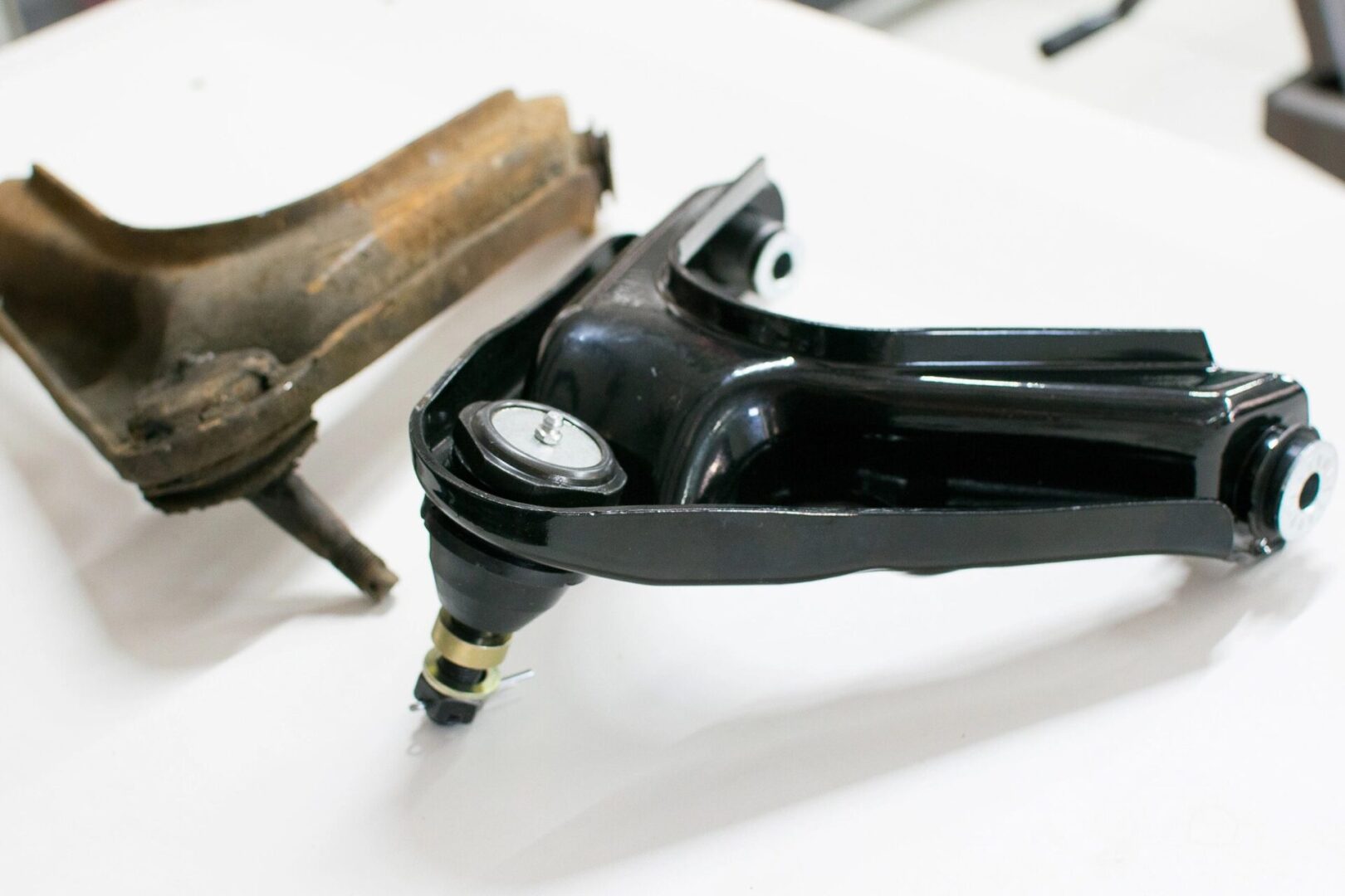 New and old car control arms.