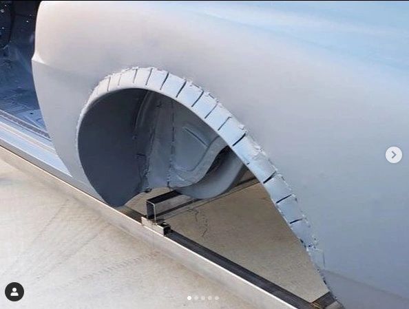 Car fender with cutout and slits.