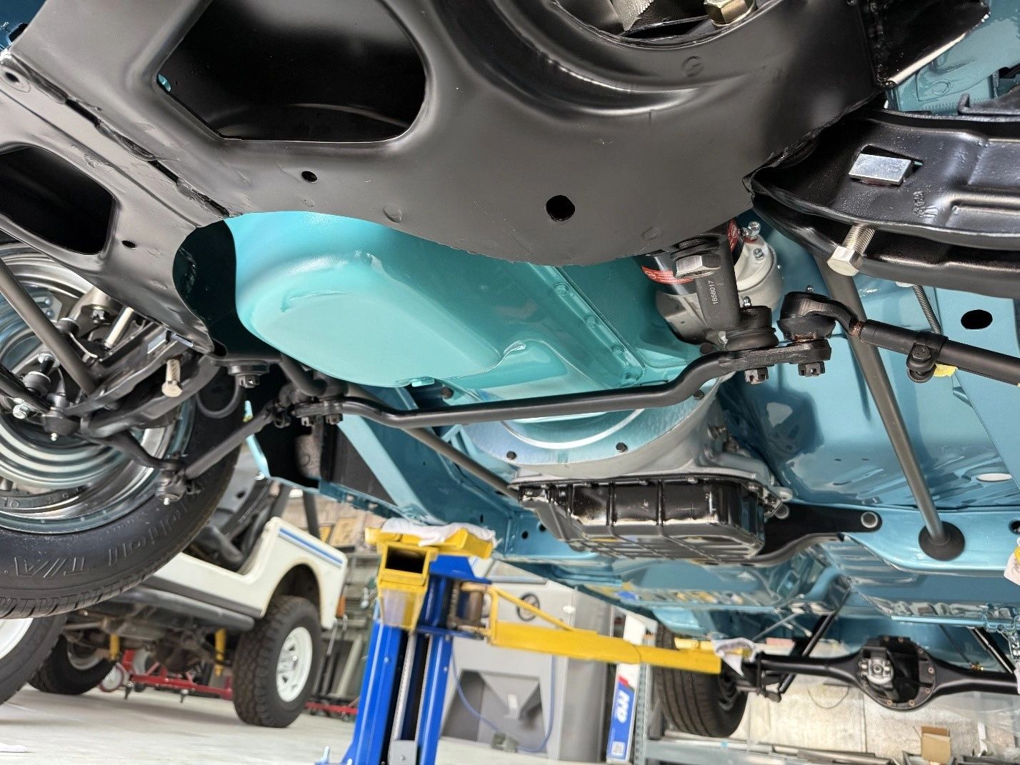 Vehicle undercarriage on a hydraulic lift.