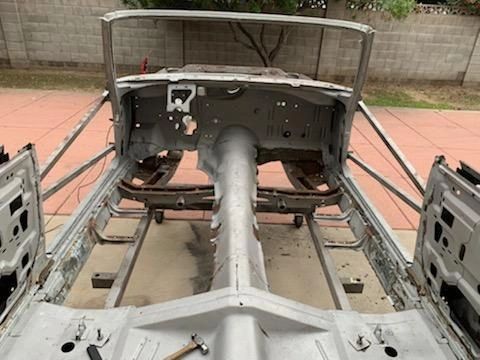Car chassis under restoration, missing components.