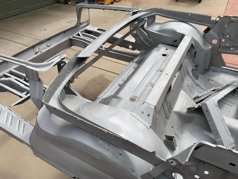 Car chassis frame on concrete surface.