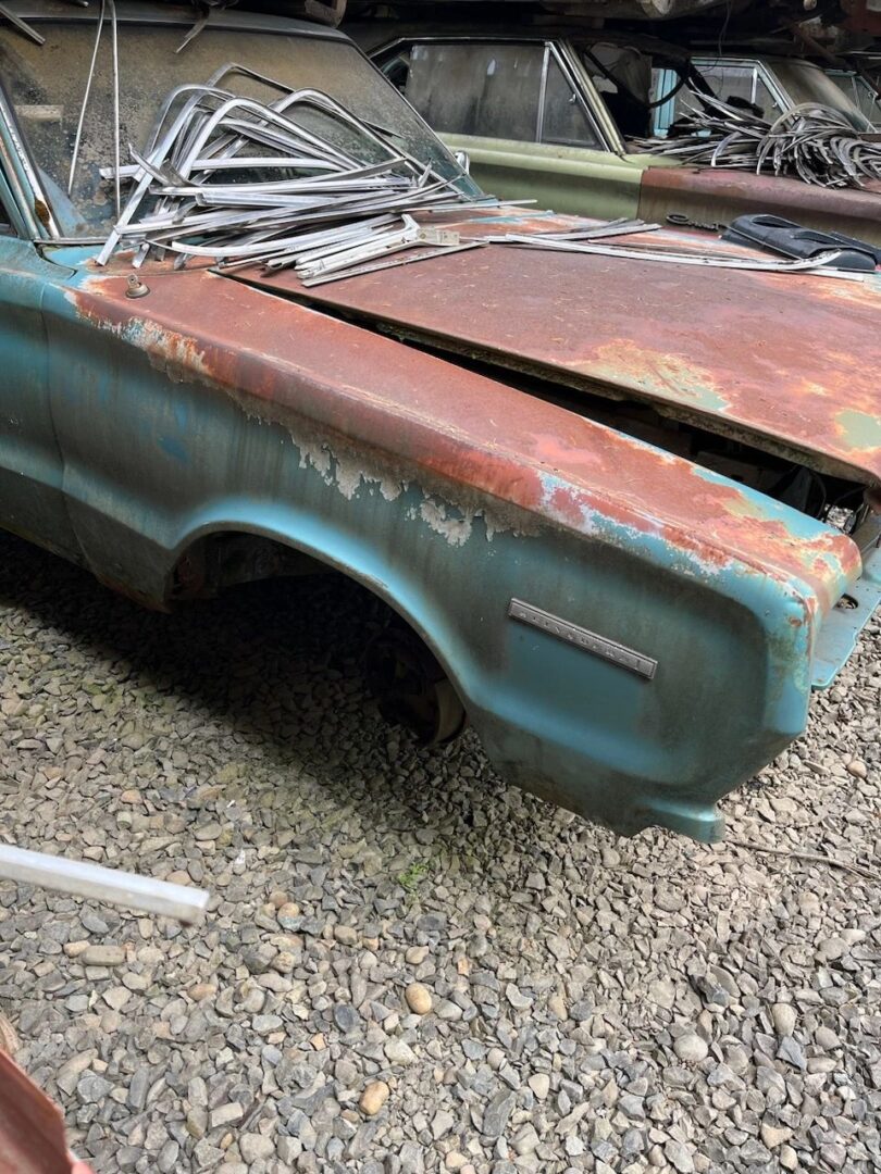 Rusty vintage car in a scrapyard.