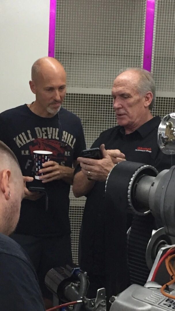 Two men looking at a smartphone.