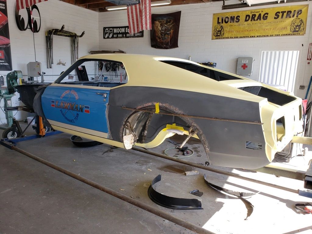 Classic car under restoration in garage.