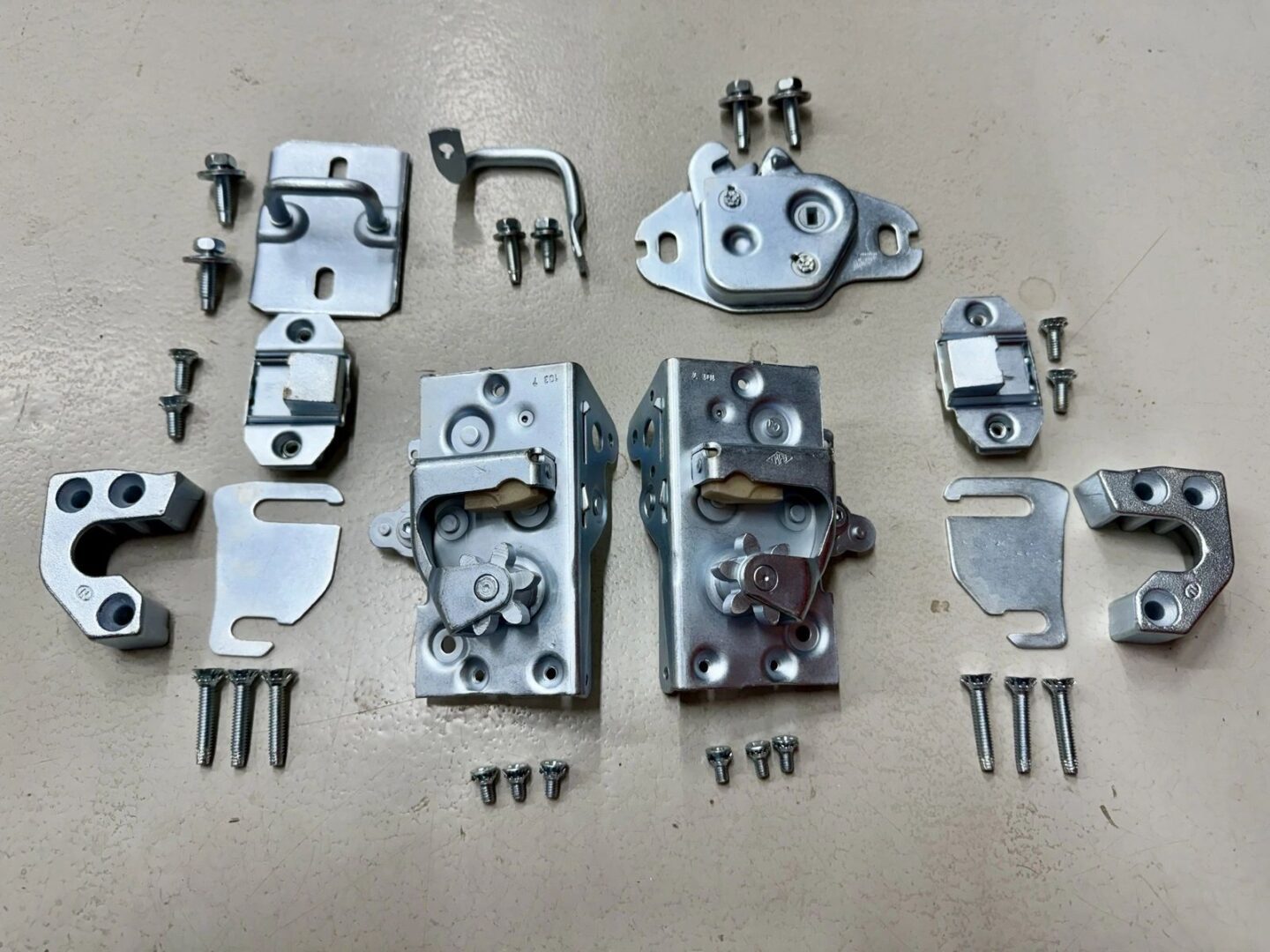 Metallic hardware components and screws on display.