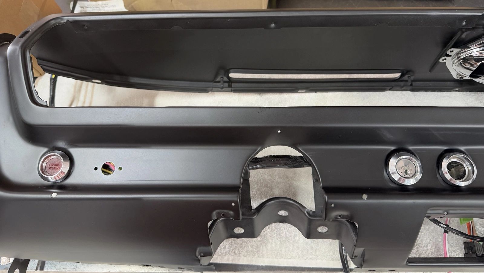 Black car dashboard with button openings.