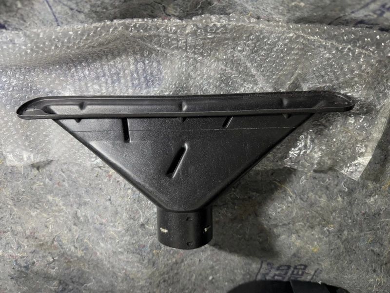 Vacuum cleaner attachment on textured surface.