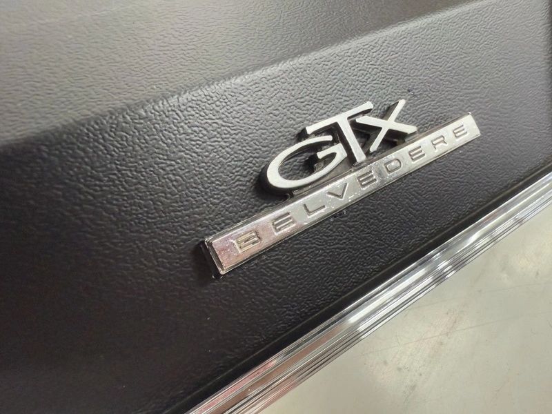 GTX Belvedere car emblem on black surface.