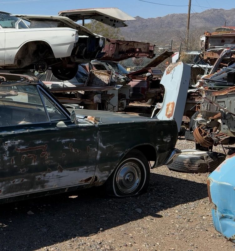 Old cars in a salvage yard.