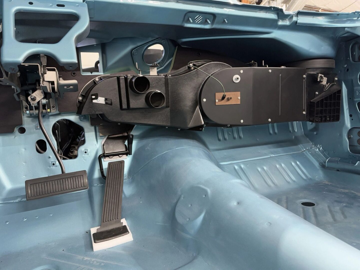 Disassembled car interior with exposed dashboard components.