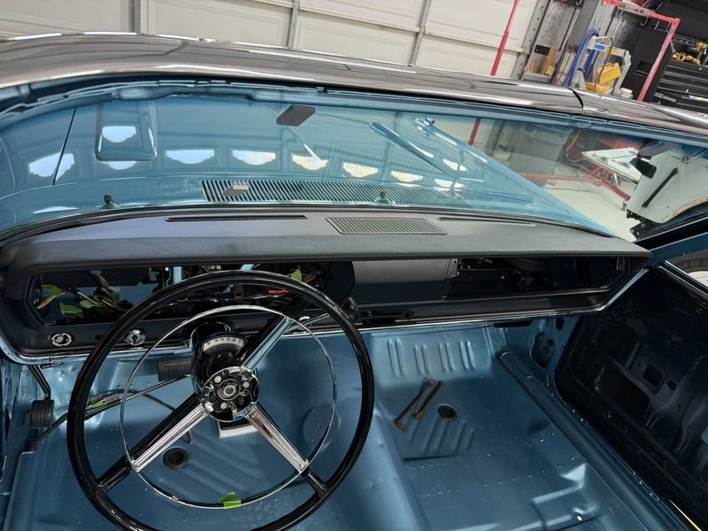 Classic car interior with steering wheel.