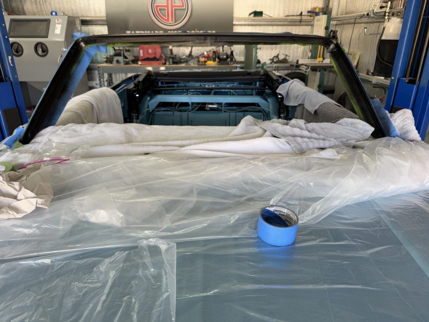 Car interior covered with plastic sheets.