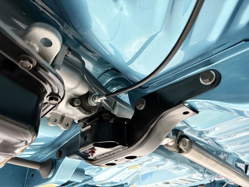 Underside view of a car's chassis components.