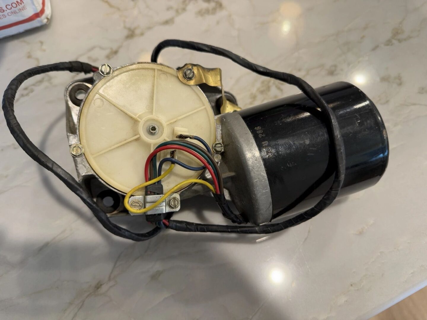 Electric motor with wires on marble surface.