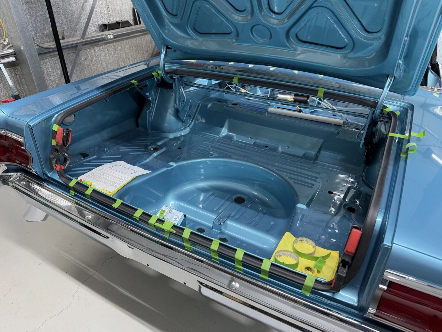 Open trunk of a vintage blue car.