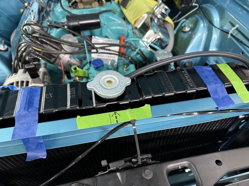 Car engine with taped radiator for maintenance.