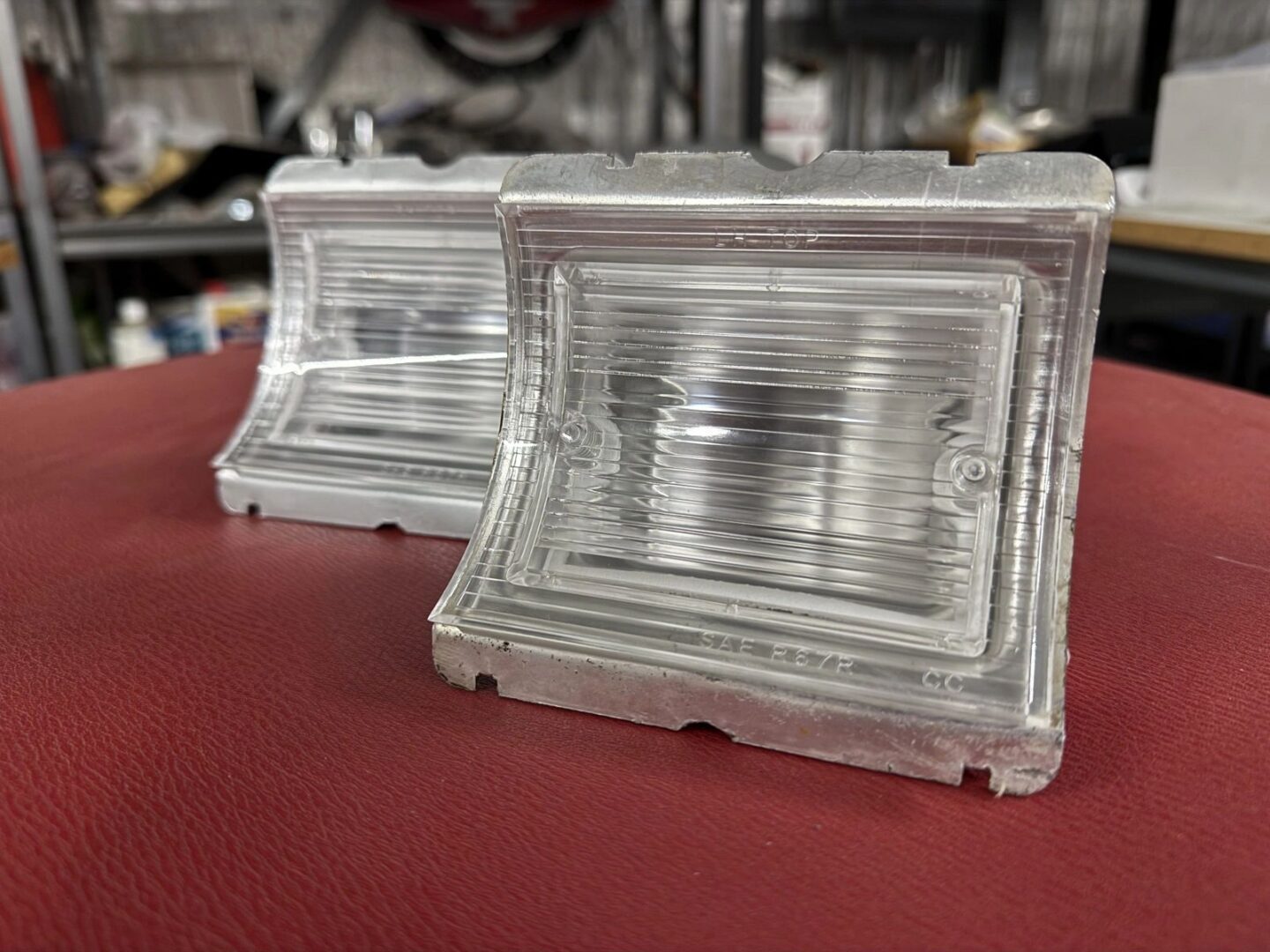 Two clear molded plastic automotive lenses.
